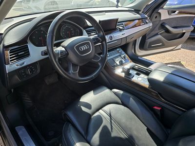 a dashboard and steering wheel of a car in a parking lot