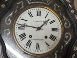 a clock with roman numerals on the face of it