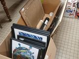 a cardboard box full of art supplies on the floor