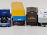 several toy trains are lined up in a row on a white surface
