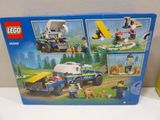 a box of lego city police vehicles on a table