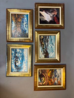 four paintings hanging on the wall of a room