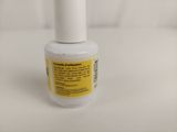 a close up of a bottle of nail polish on a white surface