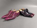 a pair of purple and black shoes sitting next to each other