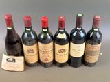 six bottles of wine are lined up in a row on a table