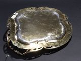 a silver tray with a handle on a black surface