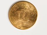 a close up of a gold coin on a white surface