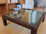 a coffee table with a glass top in a living room