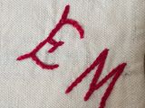 a close up of a towel with a monogram on it