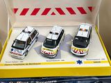 four toy ambulances sitting in a box on a table