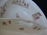 a bowl with a spoon in it that has a picture on it