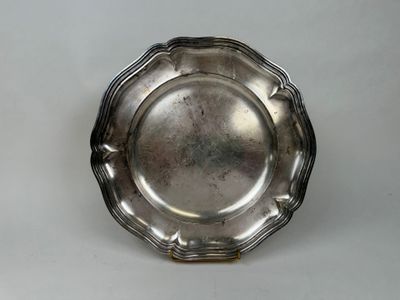 an antique silver plate on a white table with a white background