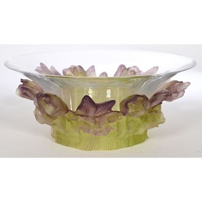 a glass bowl with flowers in it sitting on a table