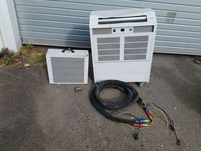 a white air conditioner sitting next to an air conditioner