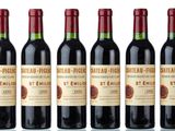 six bottles of wine are lined up in a row