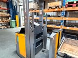 the fork lift truck is parked in the warehouse with pallets