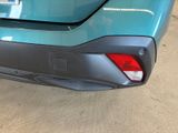 the rear end of a blue car with a number plate on it