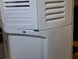 a white air conditioner sitting on top of a counter