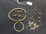 a lot of jewelry that is laying out on the table