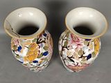 two vases that have been decorated with flowers on them