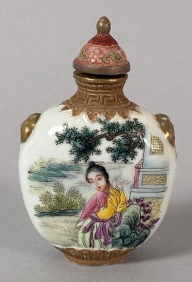 a small vase with a painting on it sitting on a table