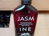 a bottle of liquid sitting on a table in front of a box