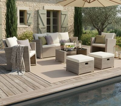 a patio with a table, chairs, umbrella, and a pool