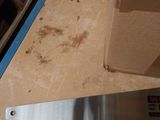 a saw on the floor next to a box of boxes
