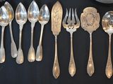 a lot of silver spoons and spoon spoons on a table