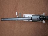 a gun that is laying on a brown surface