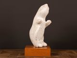 white marble sculpture of a mouse on a wooden base