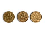 three different types of gold coins on a white surface