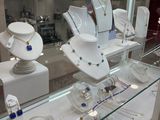 a glass display case filled with many different types of jewelry