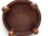 an overhead view of a wooden plate with two wooden balls on it