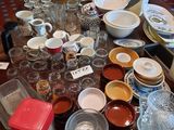 a table full of dishes and cups on the table