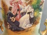 a vase with a picture of a woman playing a guitar