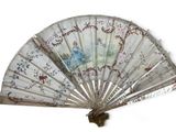 a fan that has a picture of a woman on it