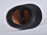 a black hat on a white surface with a black band