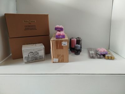 une boîte de bougies et une boîte de savons posées sur une étagère