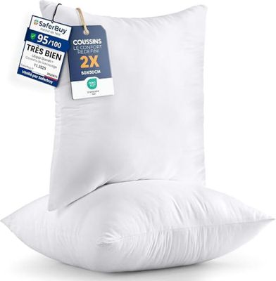 a pair of pillows sitting on top of each other on a white surface