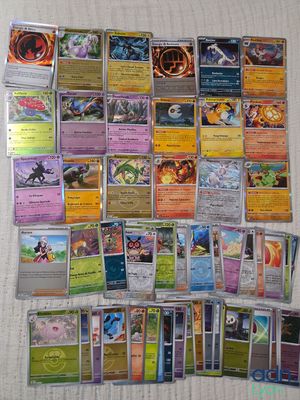 a lot of different pokemon cards on the table