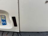 a close up of a white refrigerator with a blue sticker on it