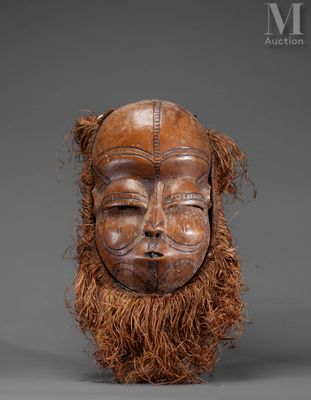 an image of a wooden mask with long hair and a beard