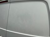 a white van that is parked on the side of the road