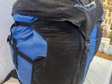a blue and black backpack sitting on a white table