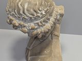 sculpture of a bust of a man with a hat on his head