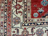 a close up of a red and blue rug on a wooden floor