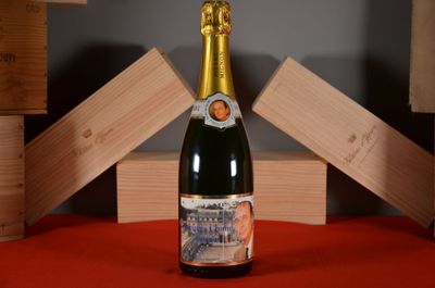 a bottle of champagne sitting on a table with wooden blocks