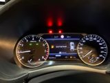 the dashboard of a car with a digital gauge and a red light