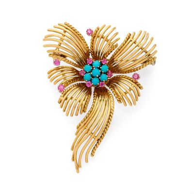 une image représentant une broche en or ornée de pierres turquoise et roses